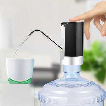 A person is pressing a button of the Automatic Portable Electric Water Pump Water Dispenser